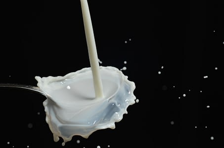 milk spilled on a spoon